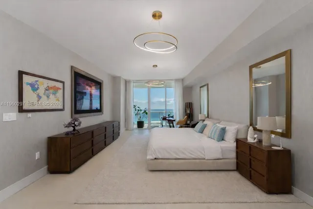 a bedroom with a bed and glass wall