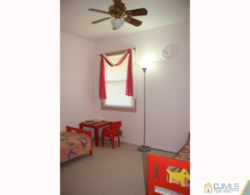 18 Roger Road Edison, NJ 08817 - Photo 8 of 8 a view of a room with furniture and a fan