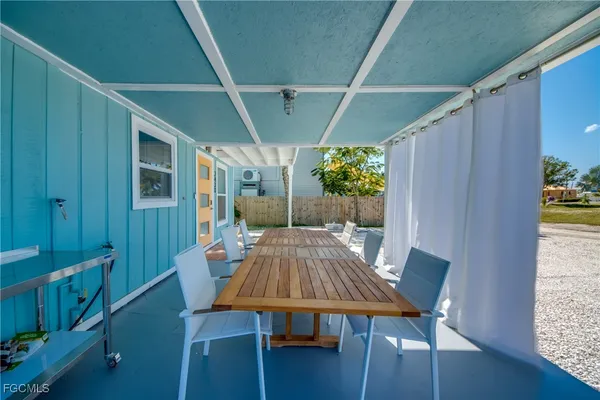 a view of a wooden table and chairs in patio