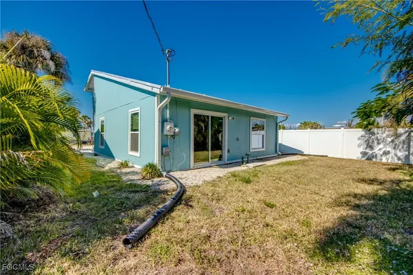 a view of white house with a yard