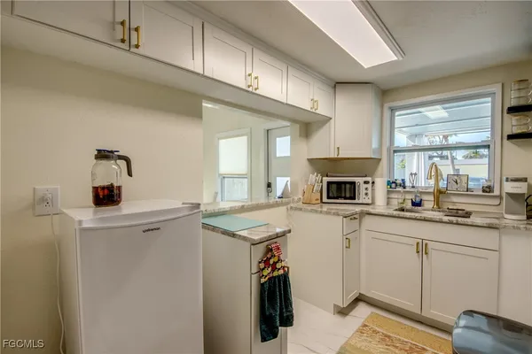a kitchen with a sink a stove and cabinets