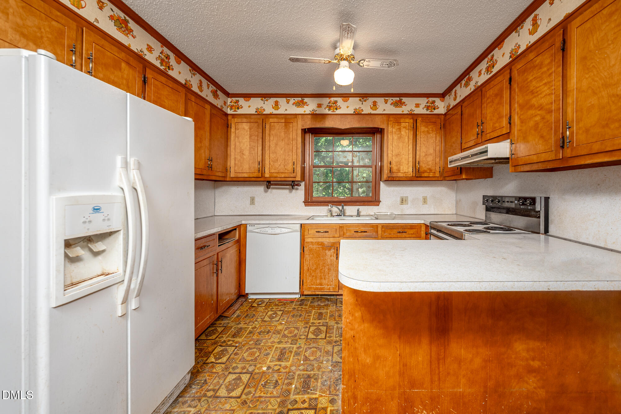 4411 Rhew Drive Durham, NC 27704 - Photo 14 of 34 a kitchen with stainless steel appliances granite countertop a refrigerator a stove and a sink
