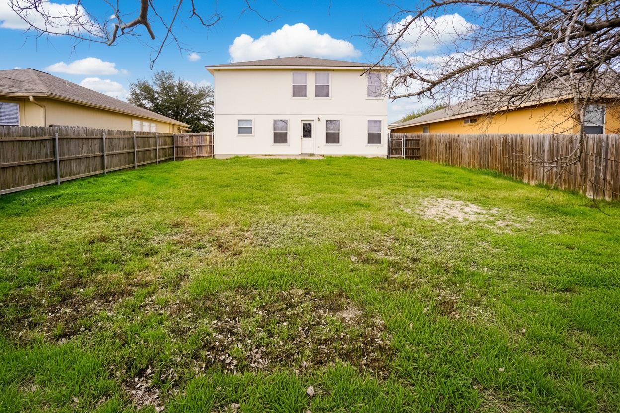 714 Lavaca Loop Elgin, TX 78621 - Photo 20 of 38 Back of property featuring a fenced backyard and stucco siding