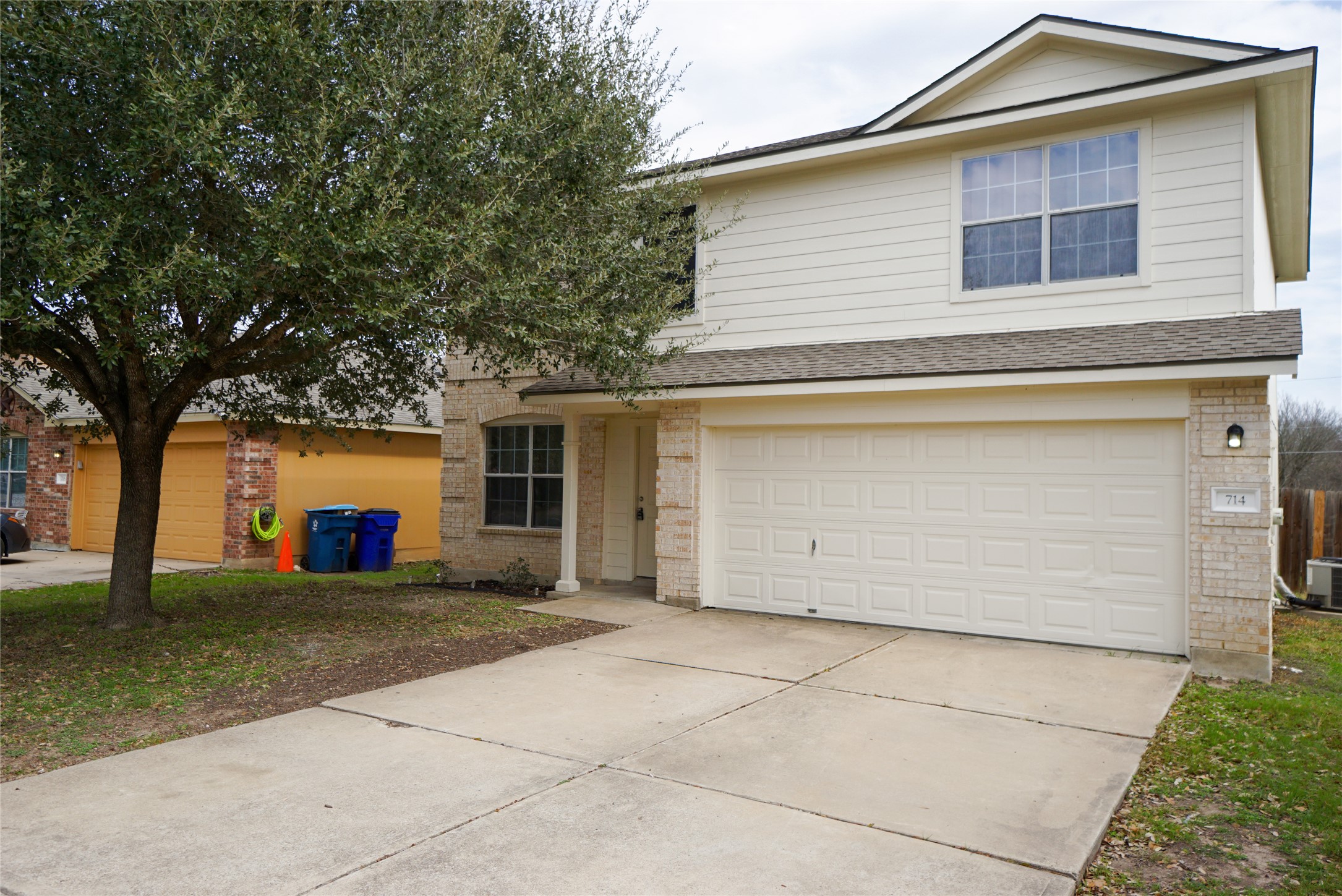 714 Lavaca Loop Elgin, TX 78621 - Photo 22 of 38 Traditional home featuring brick siding, driveway, a garage, and a shingled roof