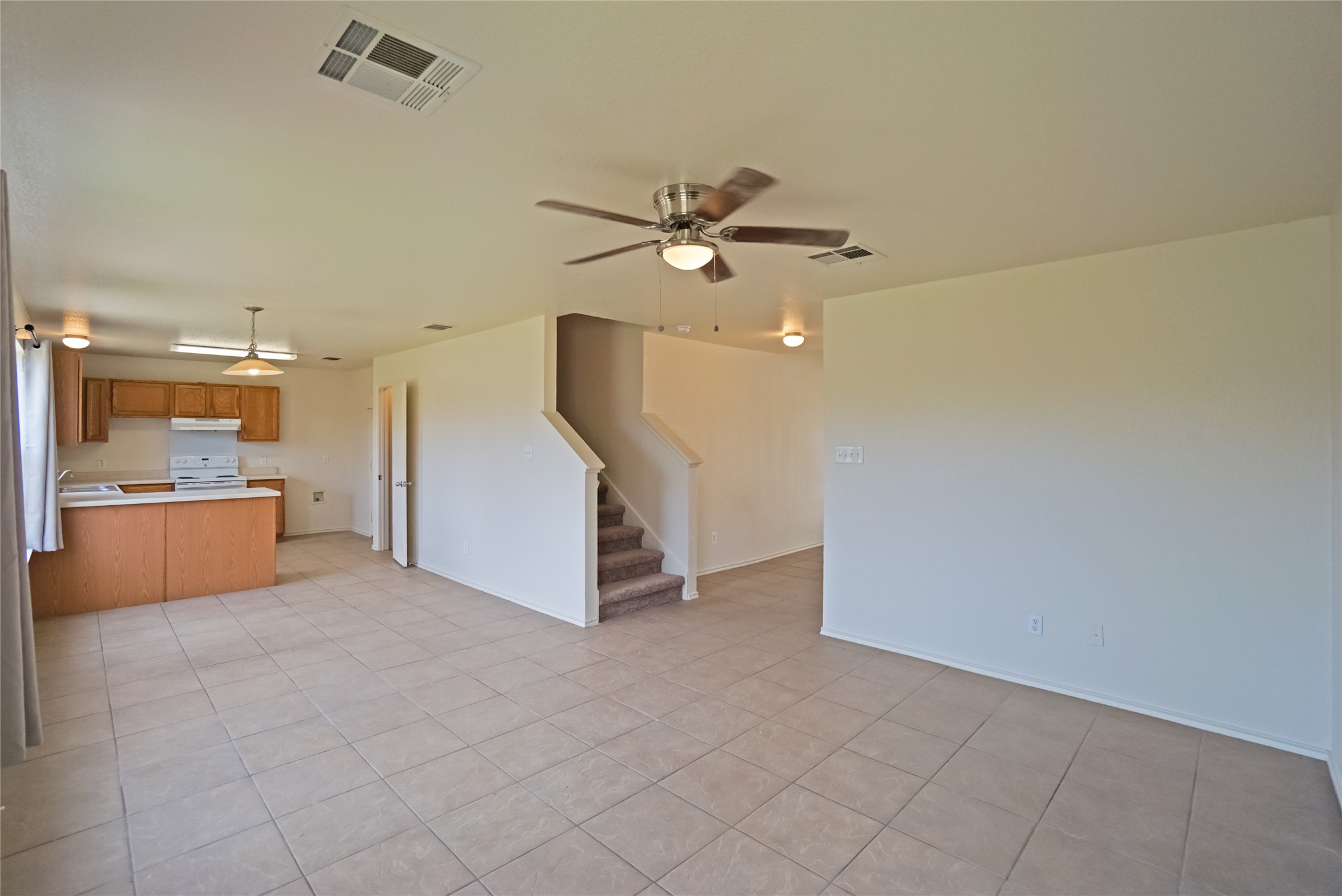 714 Lavaca Loop Elgin, TX 78621 - Photo 27 of 38 Unfurnished living room featuring ceiling fan and light tile patterned floors