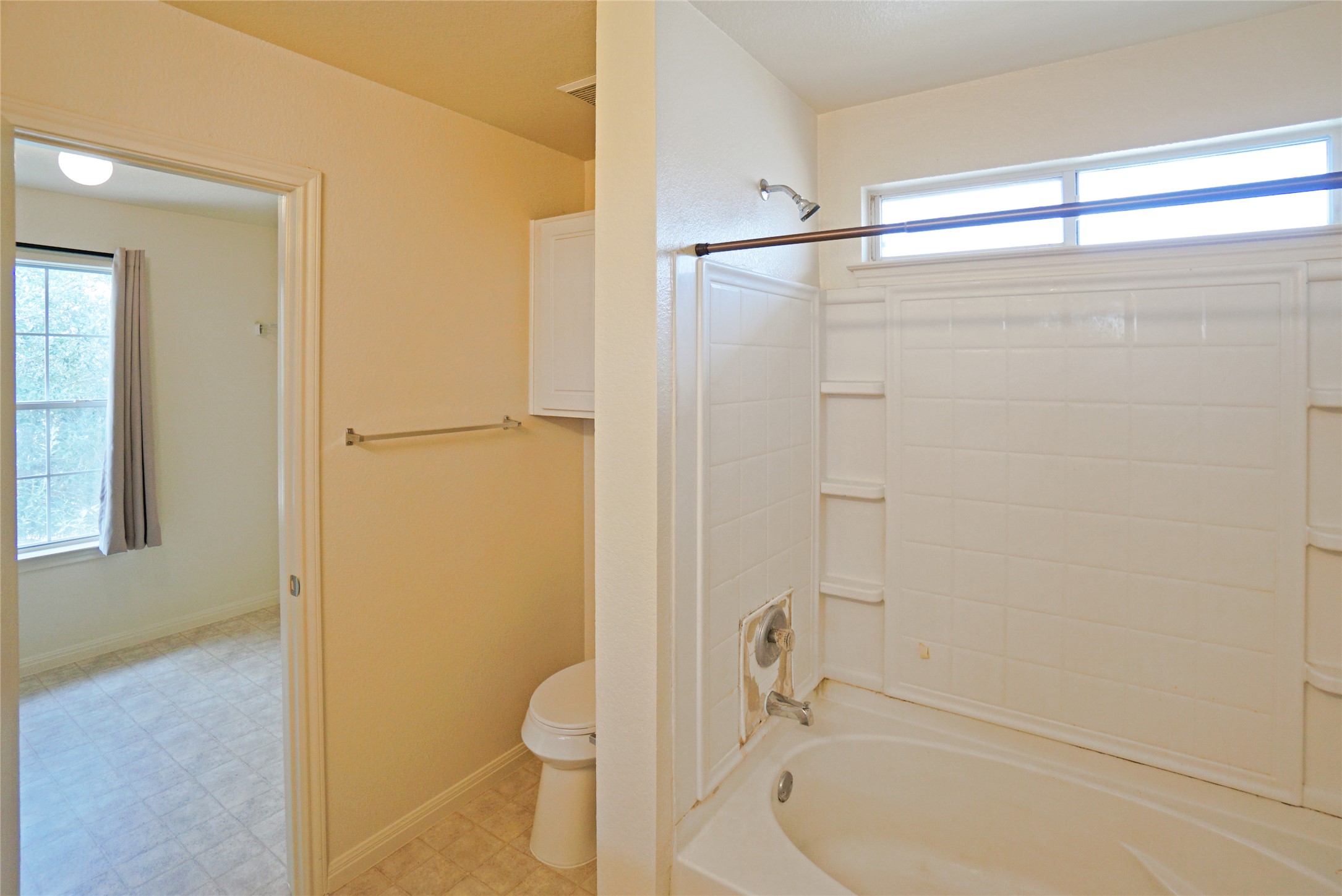 714 Lavaca Loop Elgin, TX 78621 - Photo 32 of 38 Full bath with washtub / shower combination and light floors