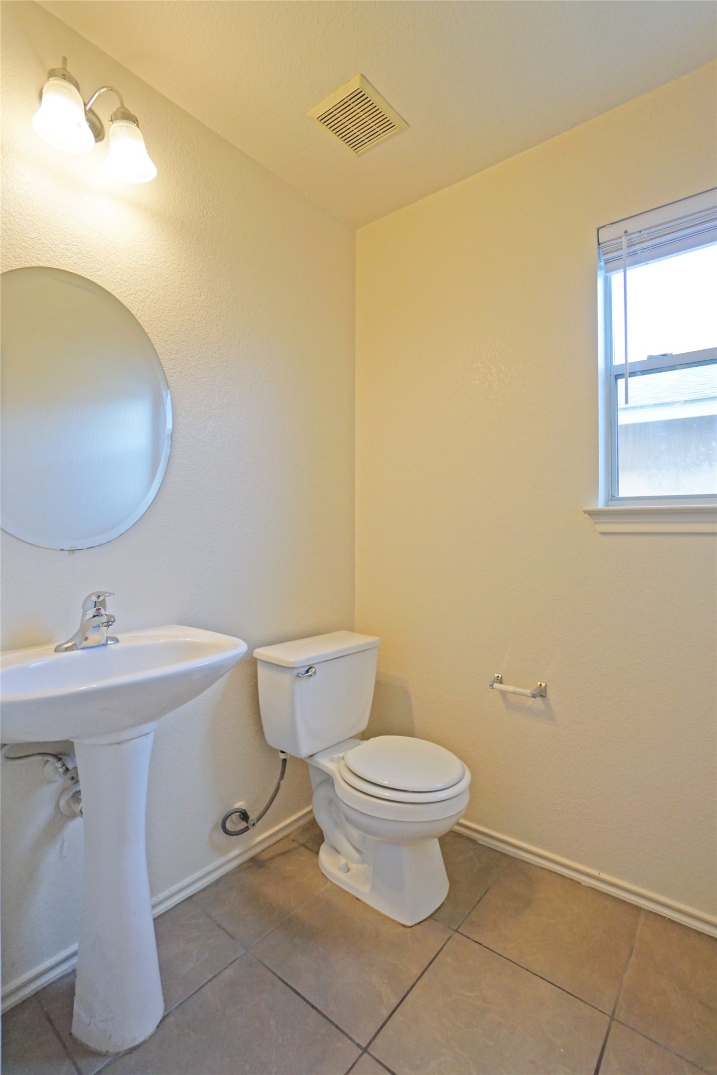 714 Lavaca Loop Elgin, TX 78621 - Photo 7 of 38 Bathroom featuring toilet and light tile patterned floors
