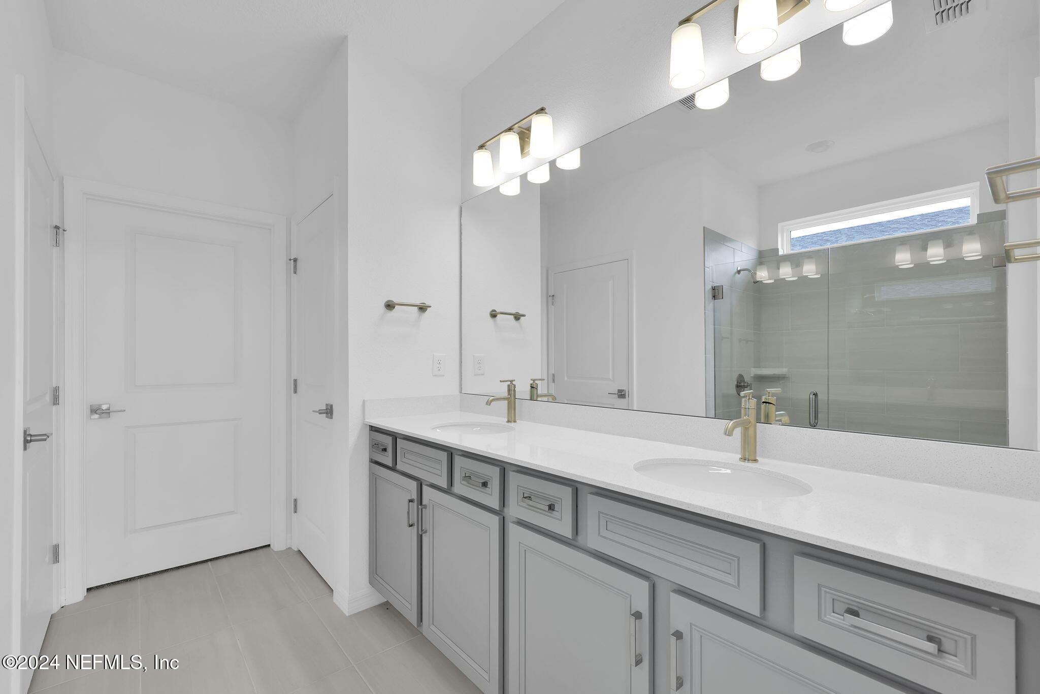 46 Fairlake Circle St. Augustine, FL 32092 - Photo 18 of 45 a bathroom with a sink a light fixture and a mirror