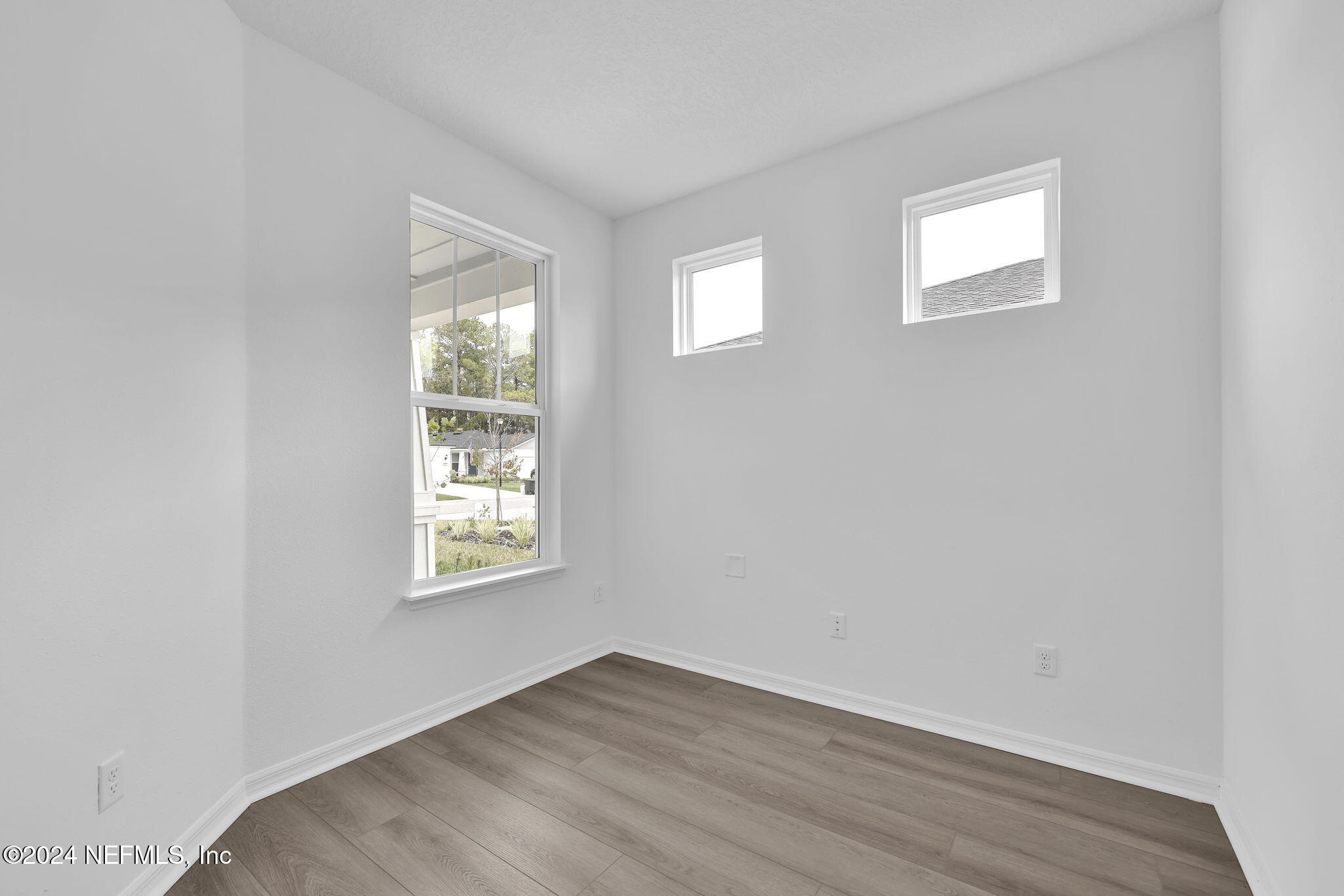 46 Fairlake Circle St. Augustine, FL 32092 - Photo 4 of 45 an empty room with wooden floor and windows