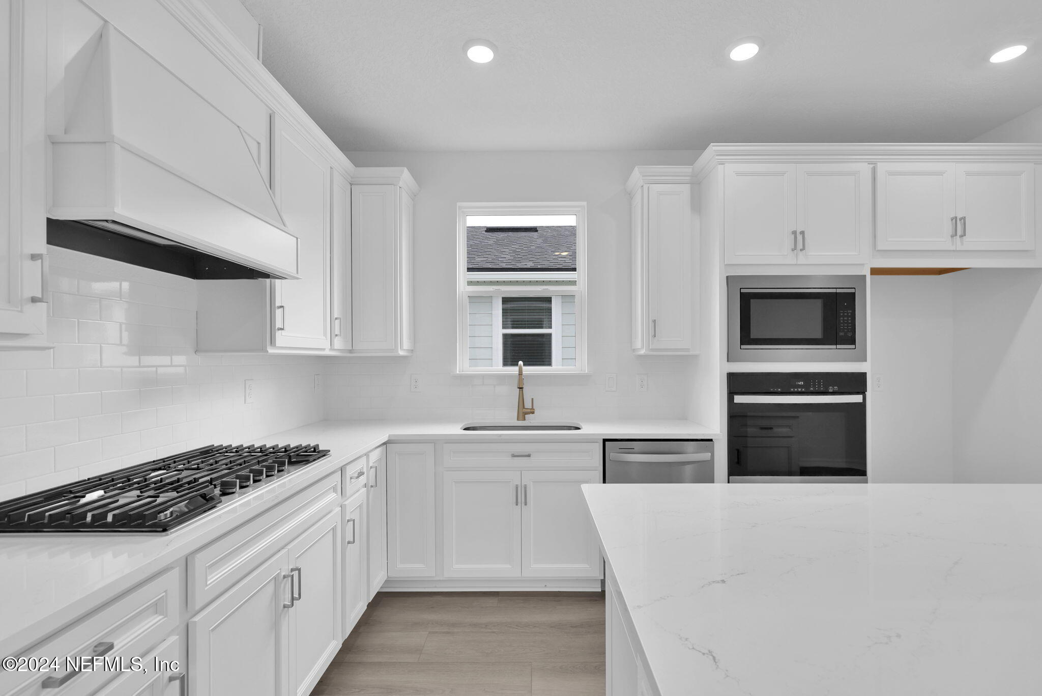 46 Fairlake Circle St. Augustine, FL 32092 - Photo 6 of 45 a kitchen with granite countertop a sink stove and refrigerator