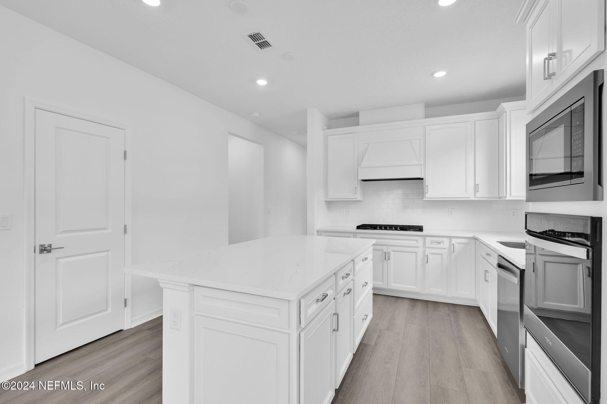 46 Fairlake Circle St. Augustine, FL 32092 - Photo 7 of 45 a kitchen with granite countertop white cabinets and white appliances