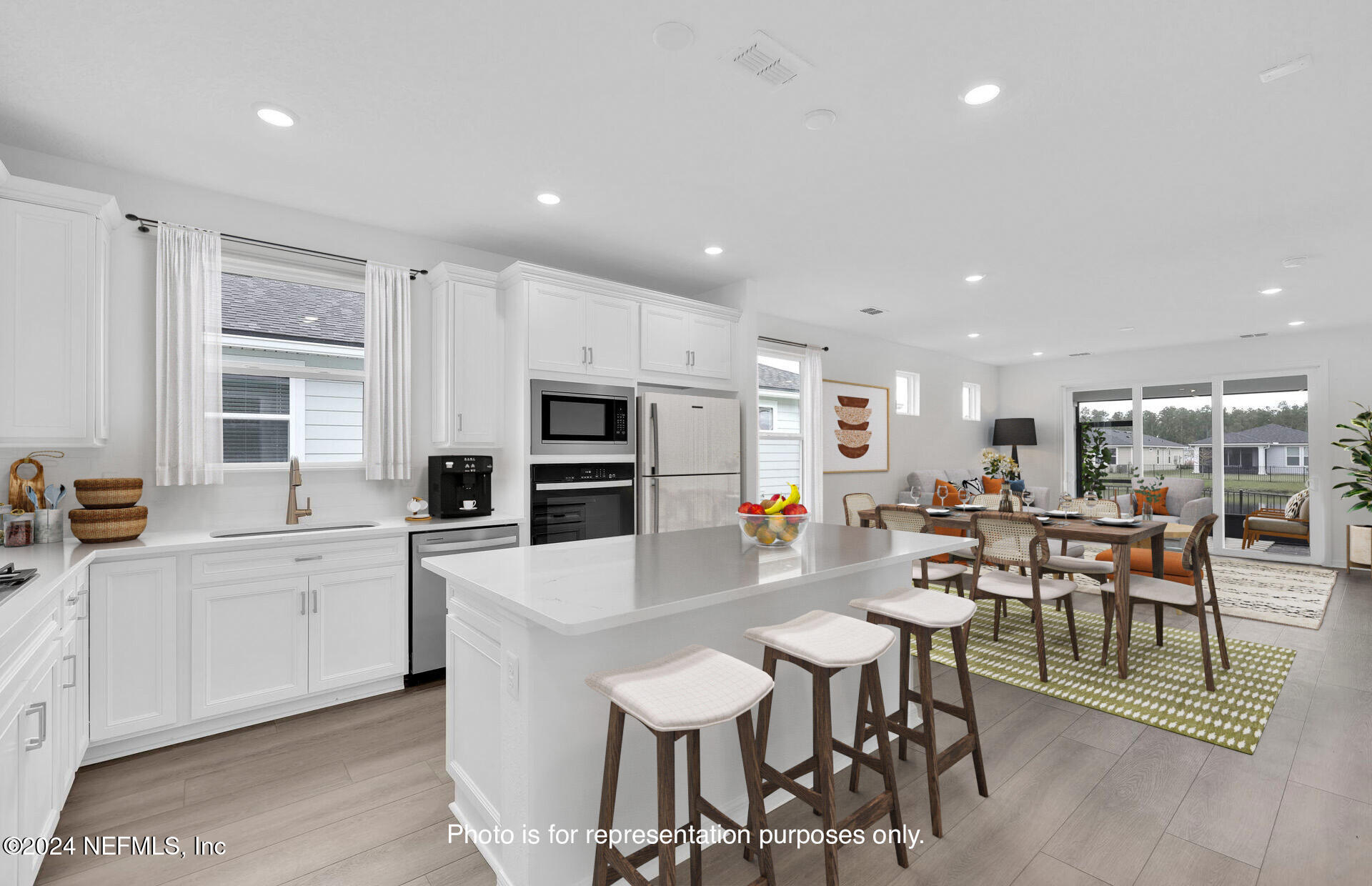 46 Fairlake Circle St. Augustine, FL 32092 - Photo 9 of 45 a kitchen with stainless steel appliances a table and chairs in it