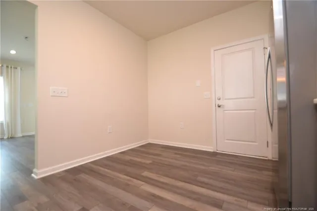 a kitchen with granite countertop a refrigerator stove and sink