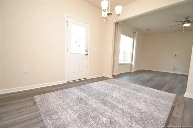 an empty room with a ceiling fan