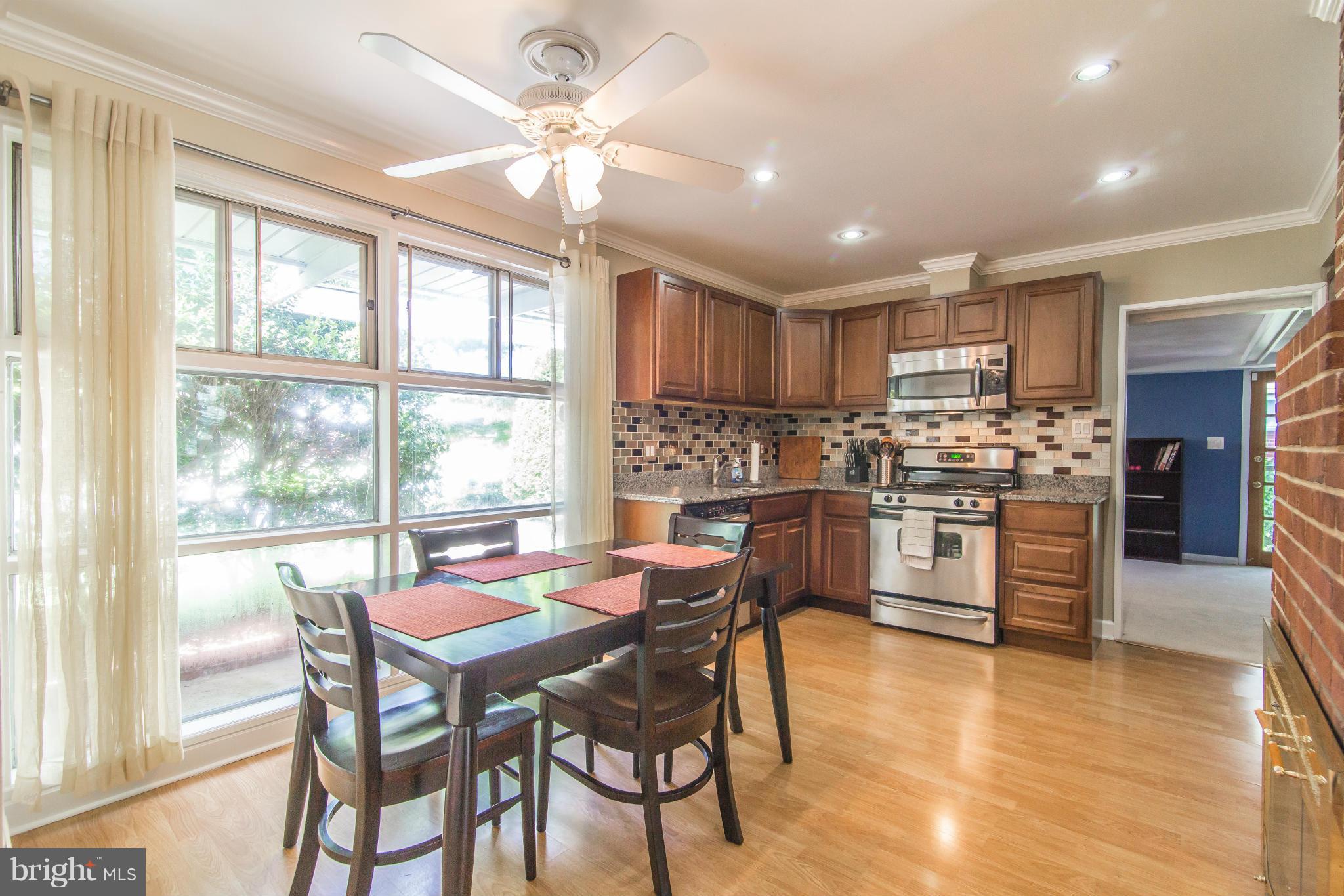 7407 Inzer Street Springfield, VA 22151 - Photo 11 of 29 a view of a dining room with furniture window and wooden floor