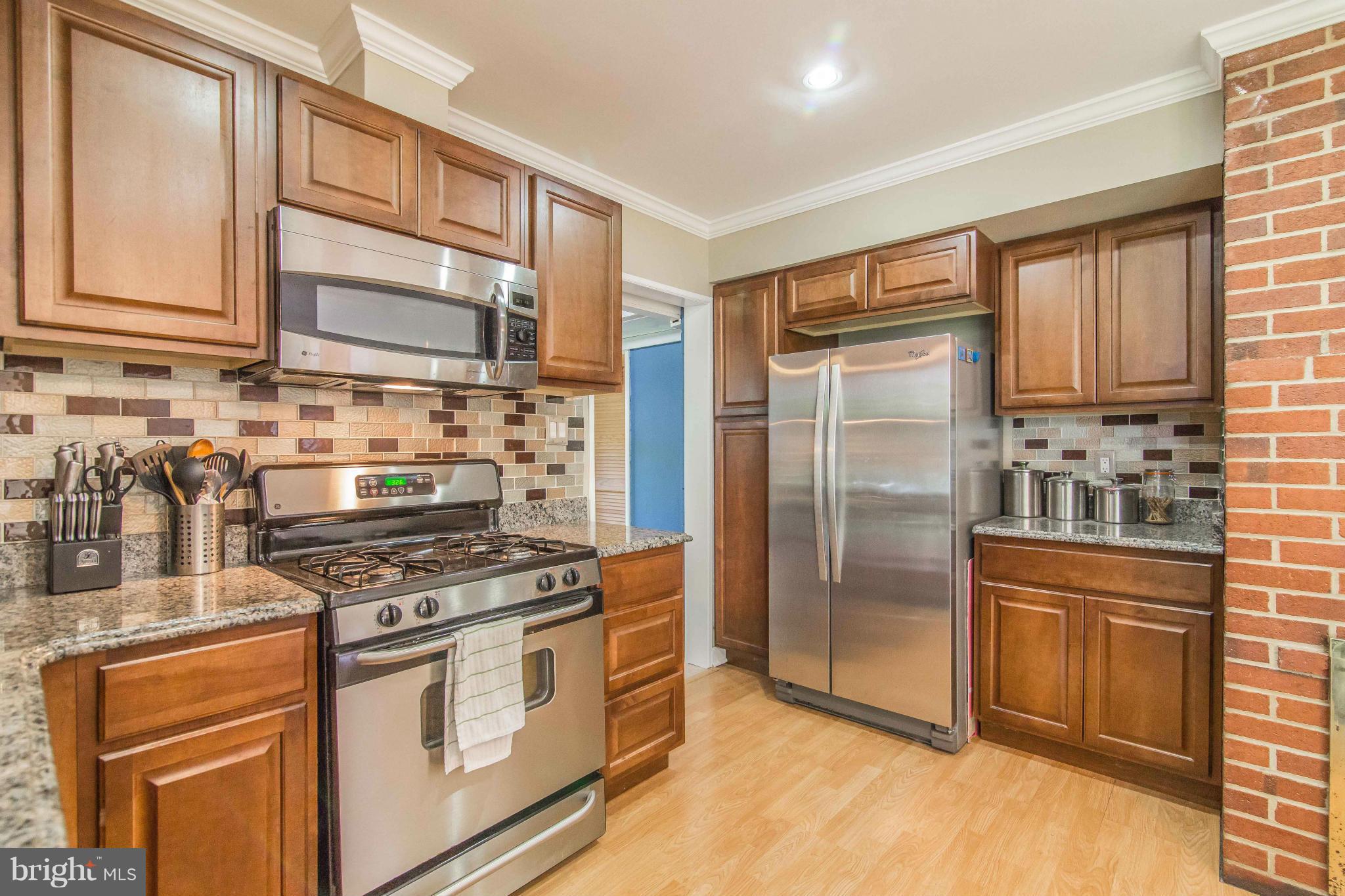 7407 Inzer Street Springfield, VA 22151 - Photo 12 of 29 a kitchen with stainless steel appliances a refrigerator stove and sink