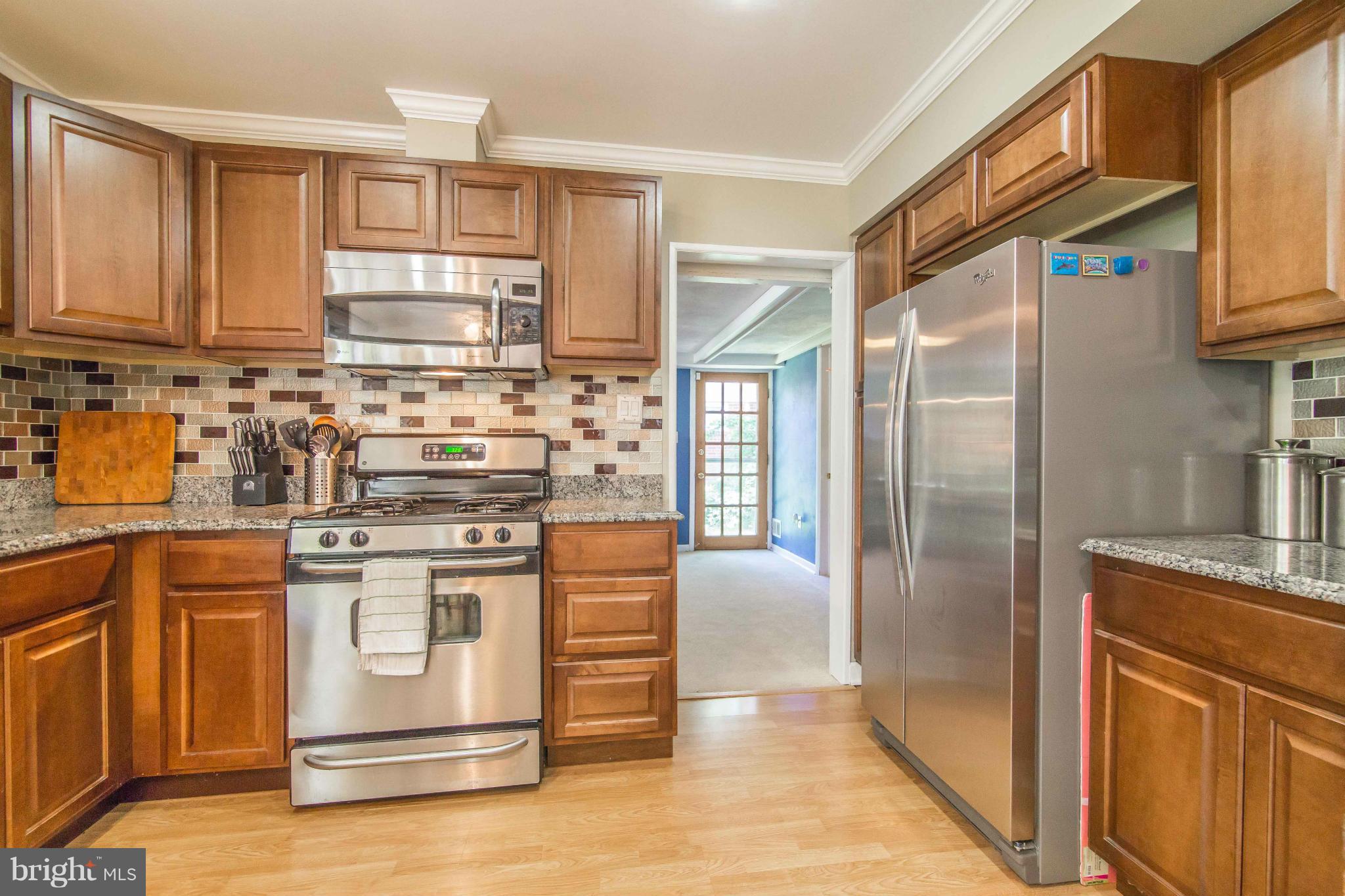 7407 Inzer Street Springfield, VA 22151 - Photo 14 of 29 a kitchen with stainless steel appliances granite countertop a refrigerator and a stove
