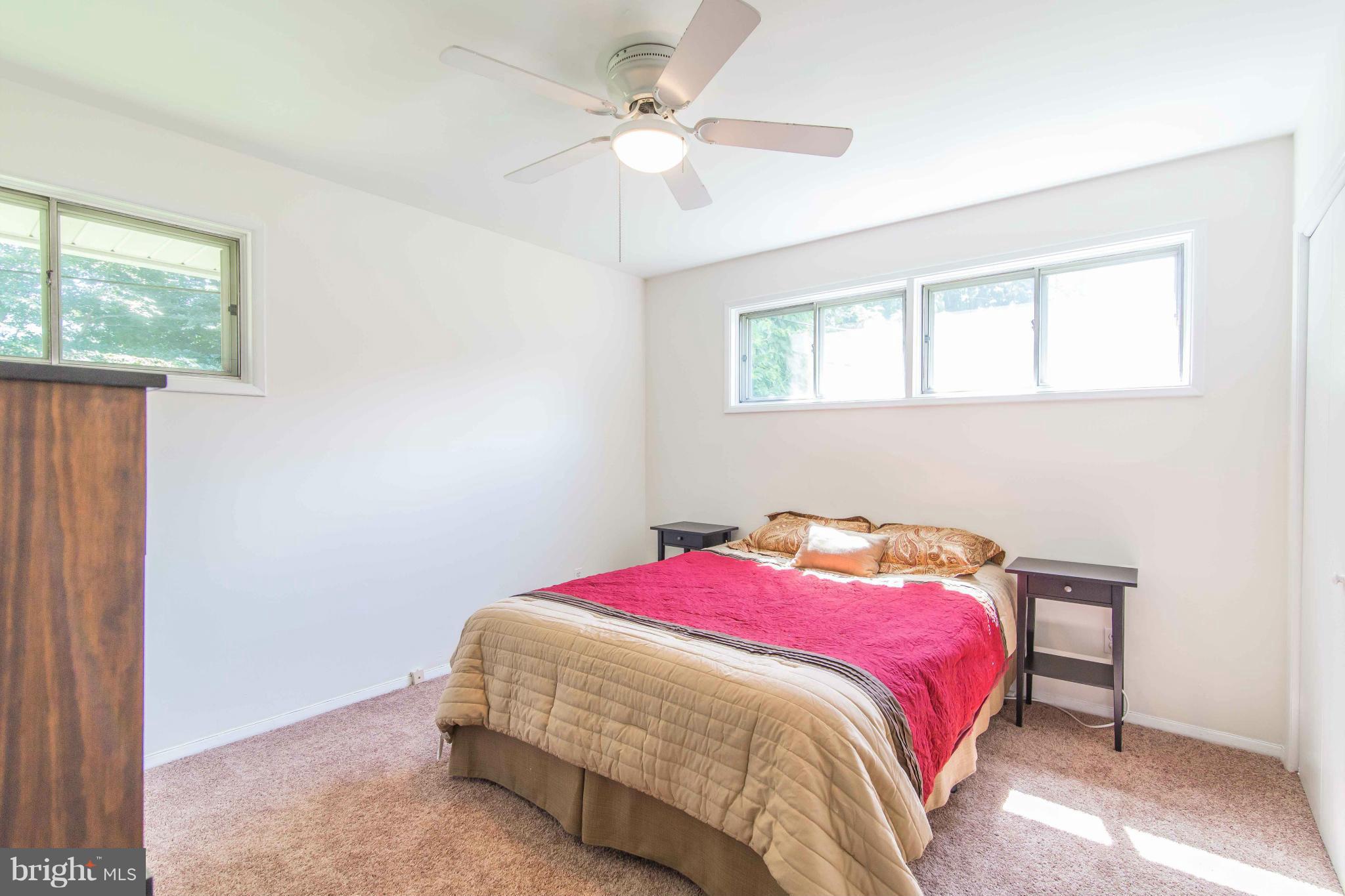 7407 Inzer Street Springfield, VA 22151 - Photo 15 of 29 a bedroom with a bed and a chandelier