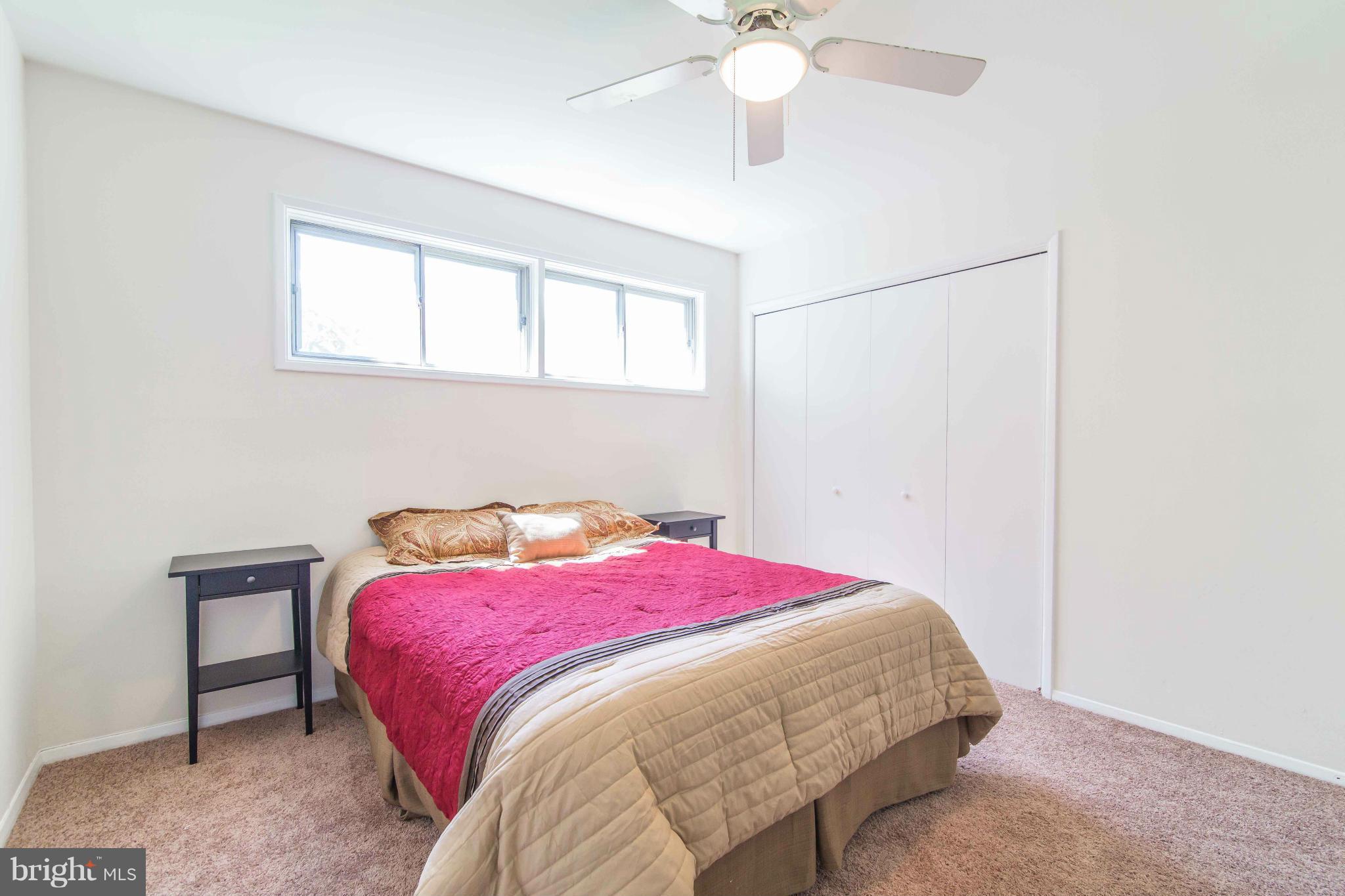 7407 Inzer Street Springfield, VA 22151 - Photo 16 of 29 a bedroom with a bed and a chandelier