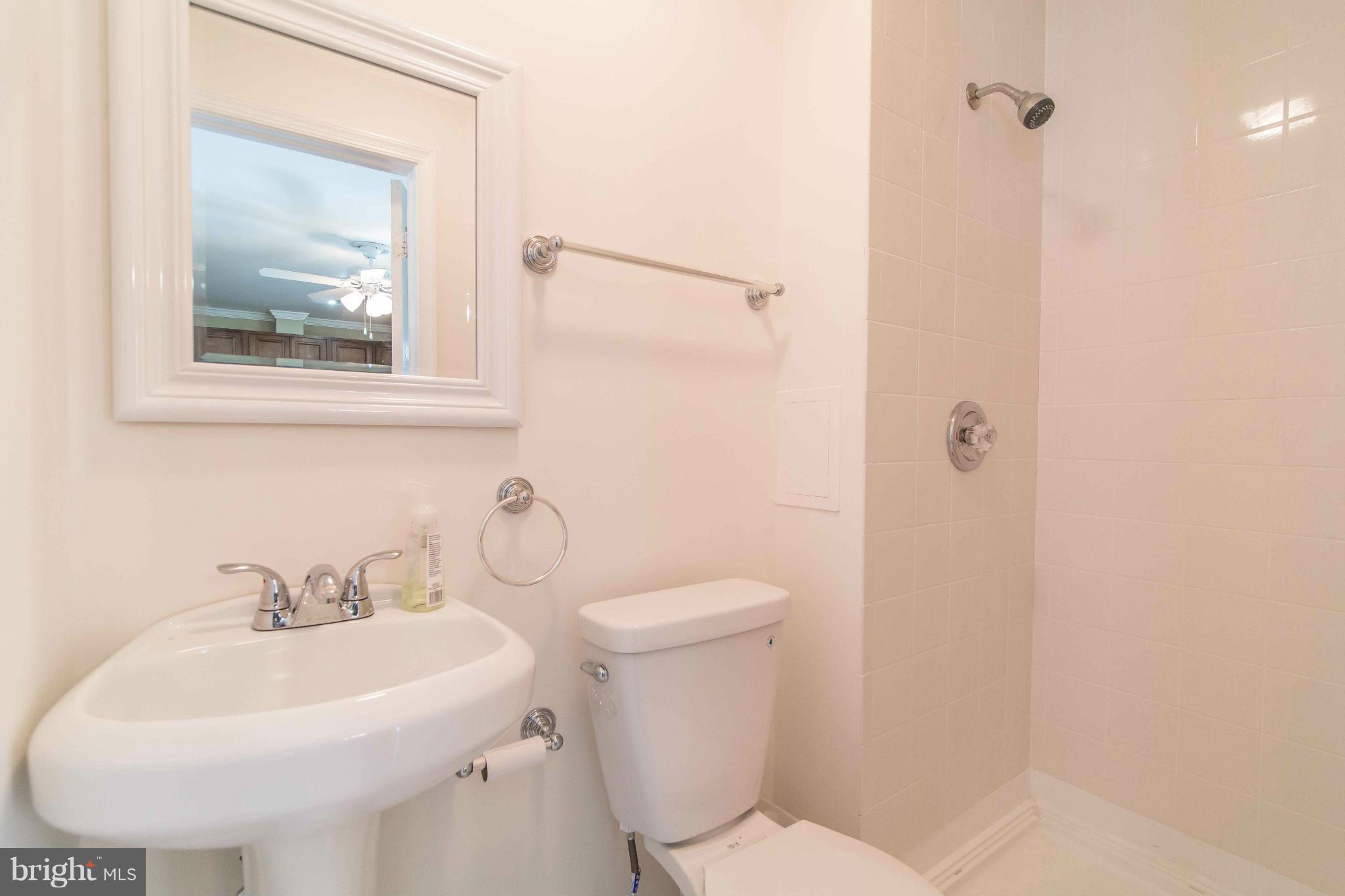 7407 Inzer Street Springfield, VA 22151 - Photo 22 of 29 a bathroom with a sink mirror and toilet
