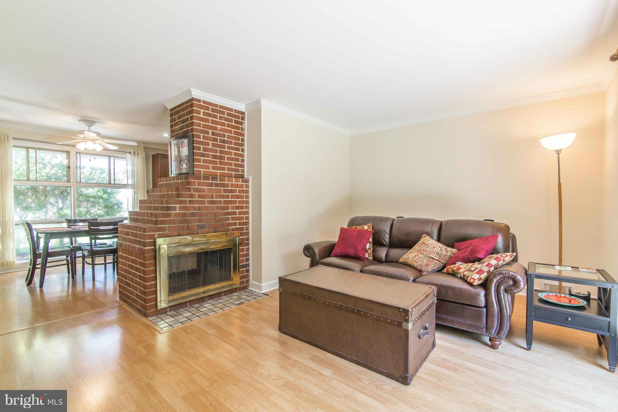 7407 Inzer Street Springfield, VA 22151 - Photo 4 of 29 a living room with furniture a fireplace and a floor to ceiling window