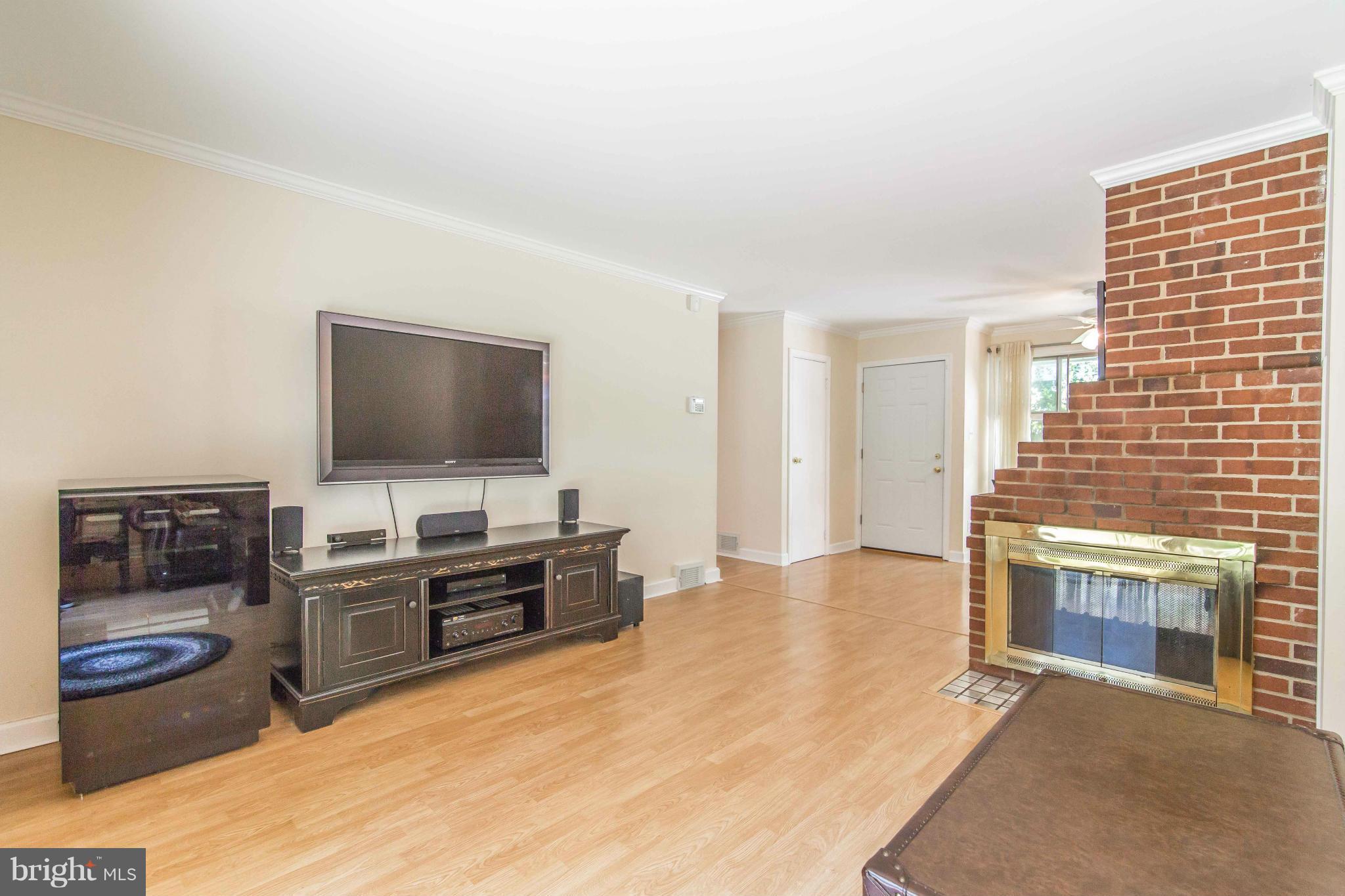 7407 Inzer Street Springfield, VA 22151 - Photo 6 of 29 a living room with furniture and a flat screen tv