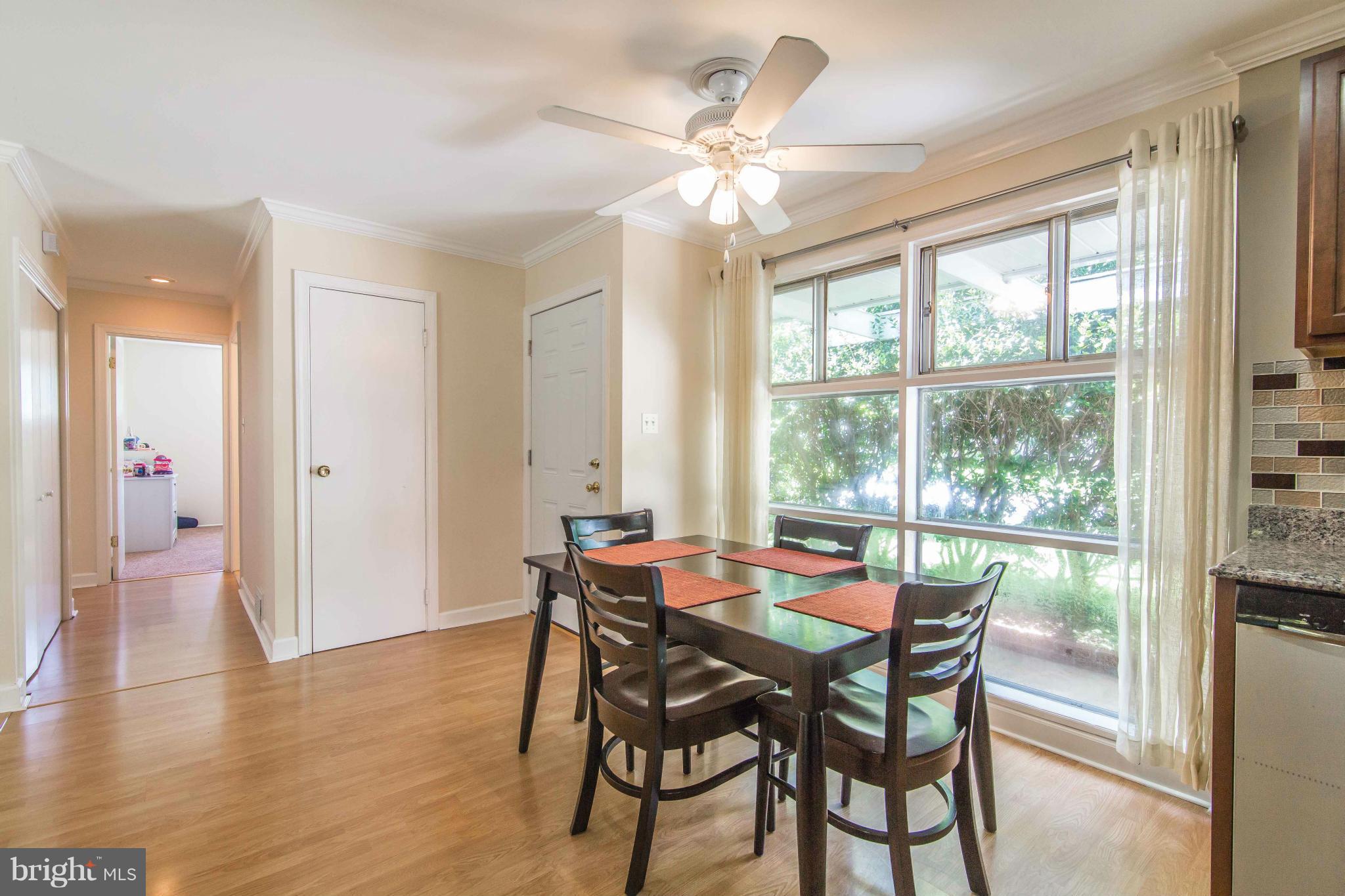 7407 Inzer Street Springfield, VA 22151 - Photo 8 of 29 a dining room with furniture window wooden floor