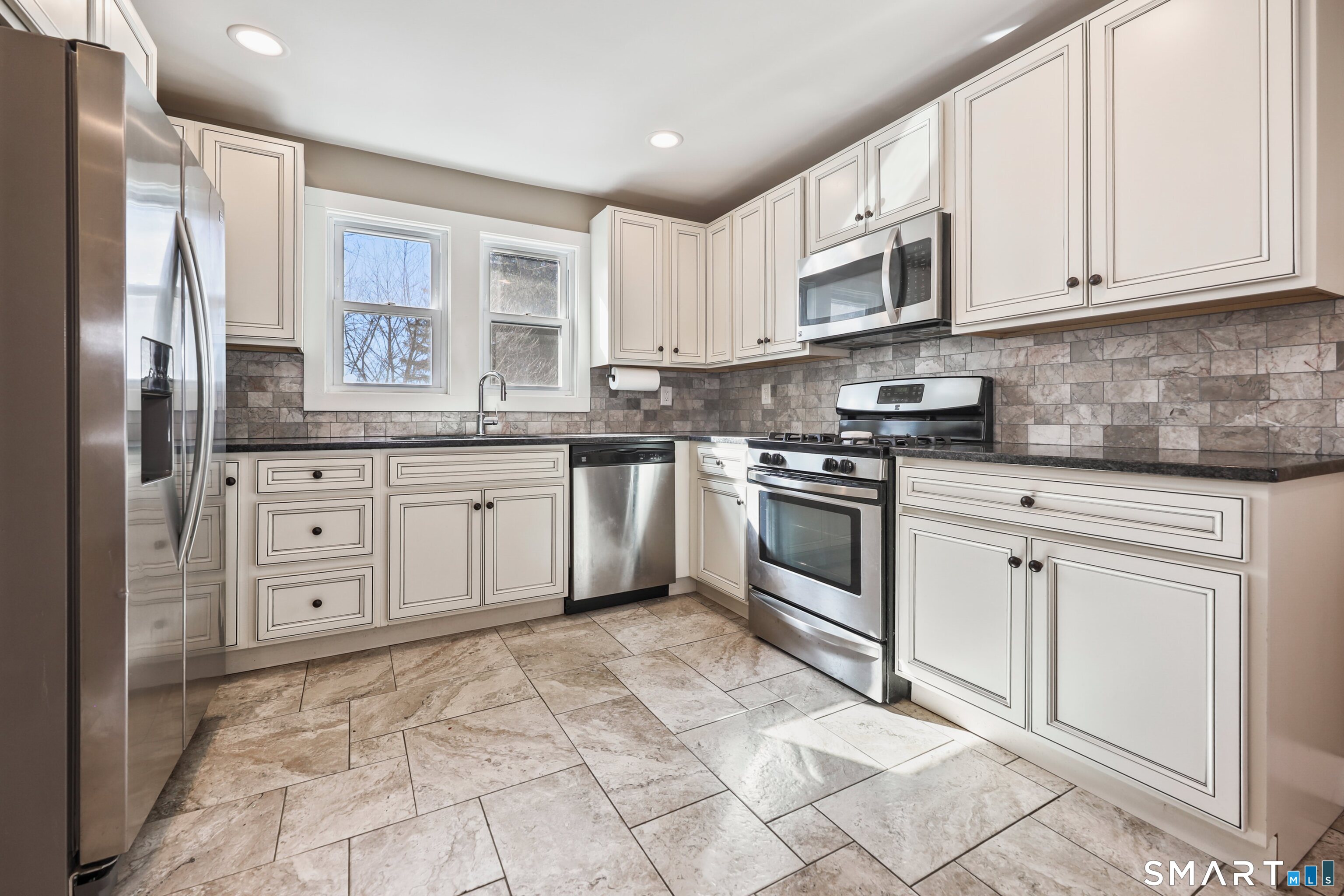 116 Hillside Avenue Torrington, CT 06790 - Photo 11 of 40 a kitchen with stainless steel appliances granite countertop a stove a sink and a refrigerator