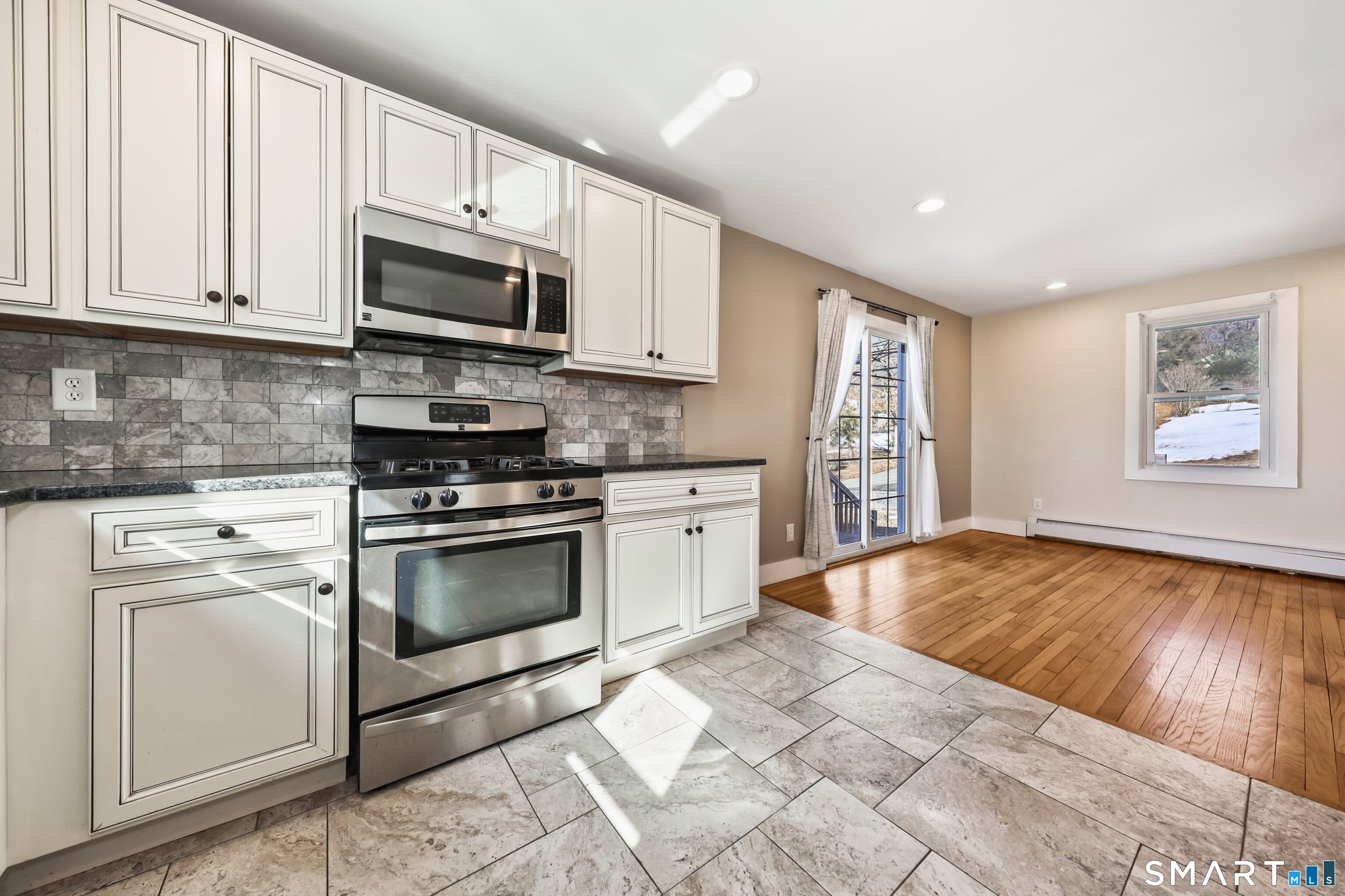 116 Hillside Avenue Torrington, CT 06790 - Photo 13 of 40 a kitchen with stainless steel appliances granite countertop a stove a sink and a microwave
