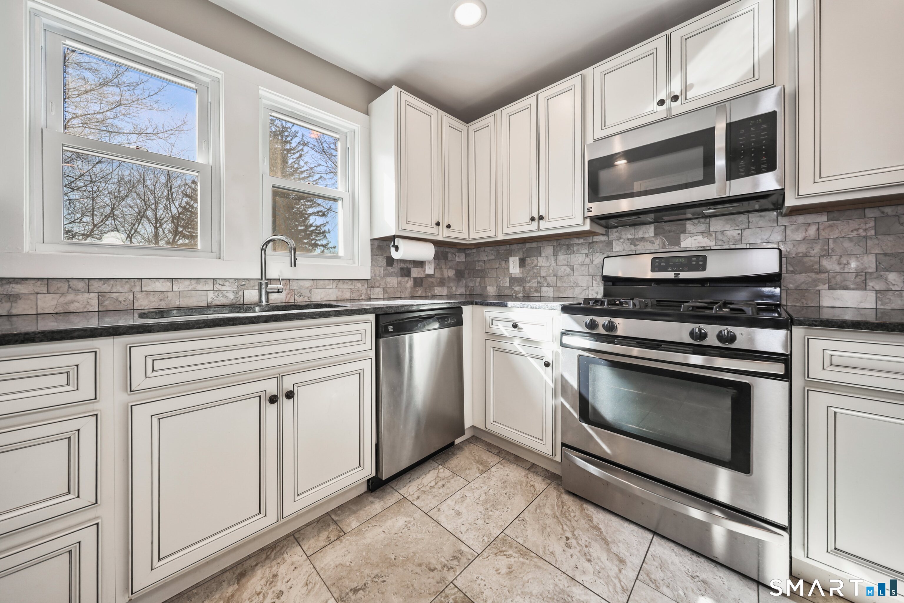 116 Hillside Avenue Torrington, CT 06790 - Photo 14 of 40 a kitchen with granite countertop white cabinets stainless steel appliances and a sink