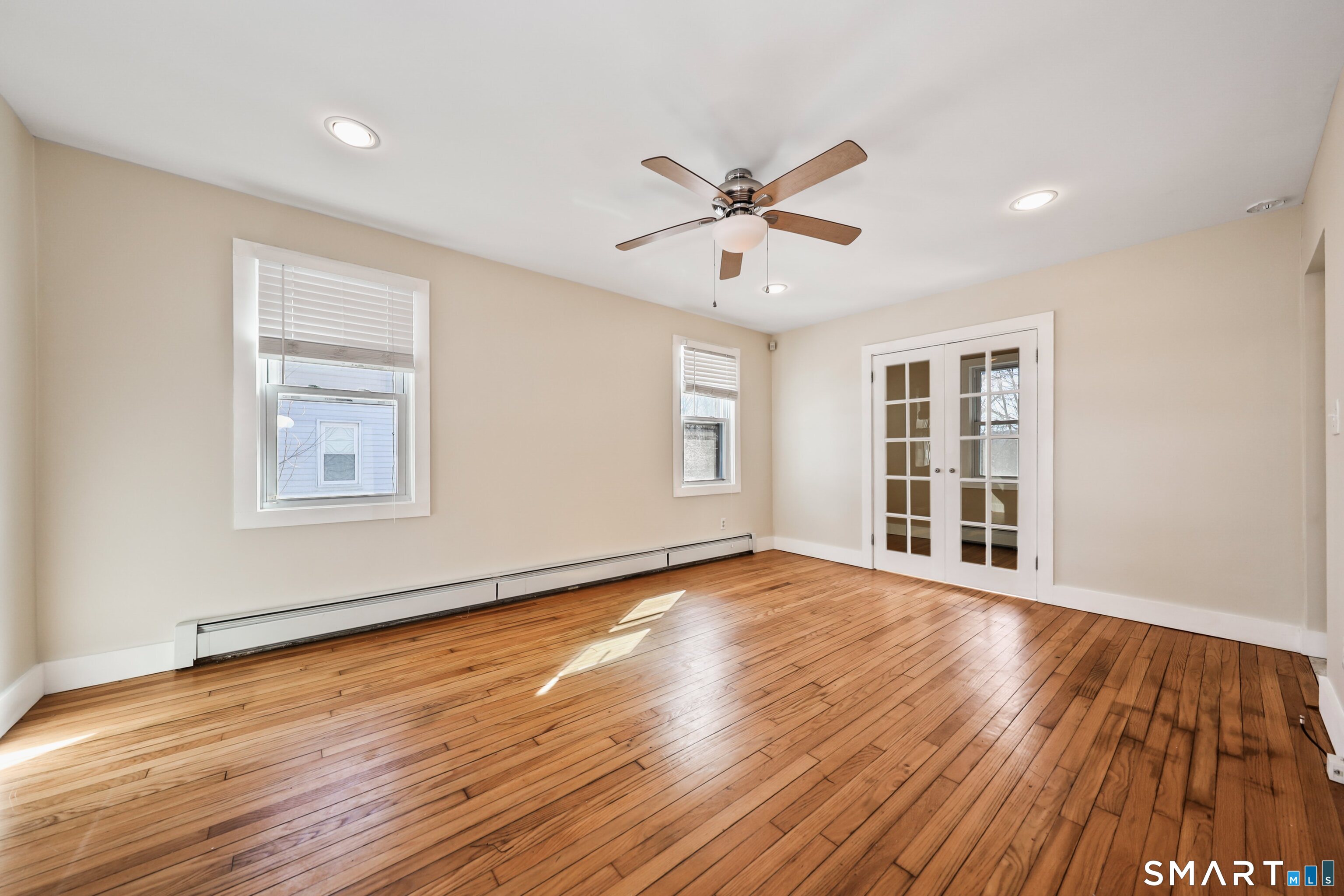 116 Hillside Avenue Torrington, CT 06790 - Photo 21 of 40 a view of an empty room with a window and wooden floor