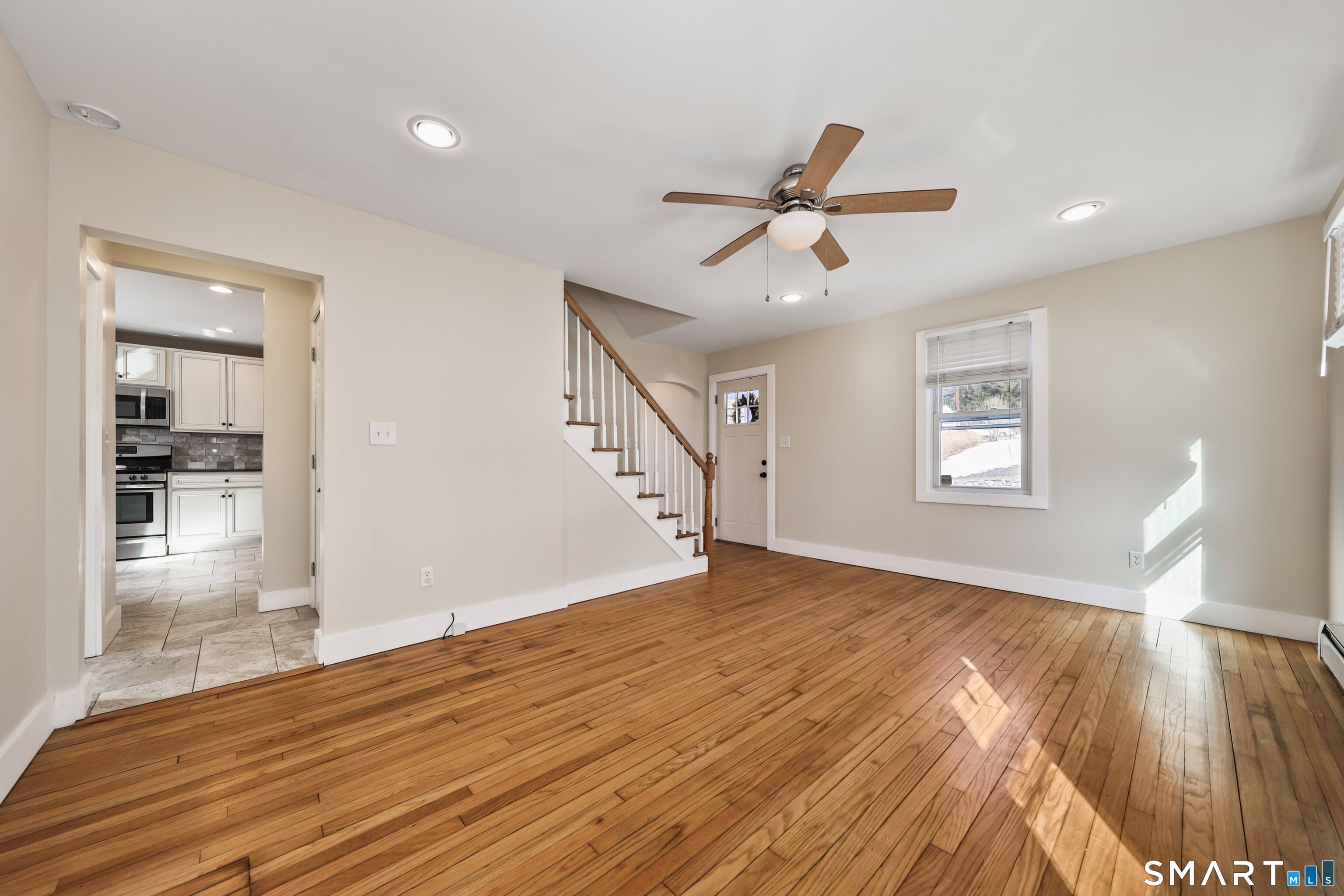 116 Hillside Avenue Torrington, CT 06790 - Photo 22 of 40 a view of empty room with wooden floor and fan