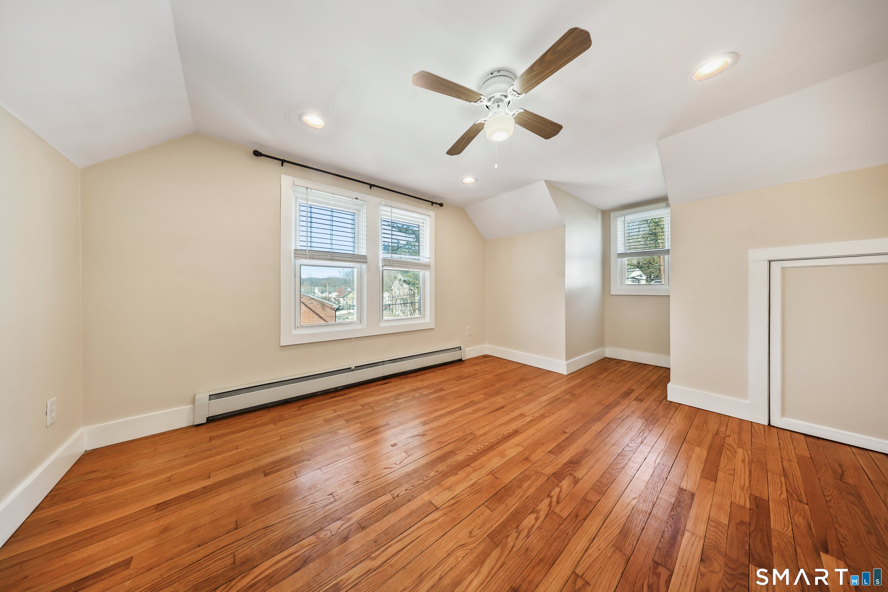 116 Hillside Avenue Torrington, CT 06790 - Photo 28 of 40 an empty room with wooden floor chandelier and windows