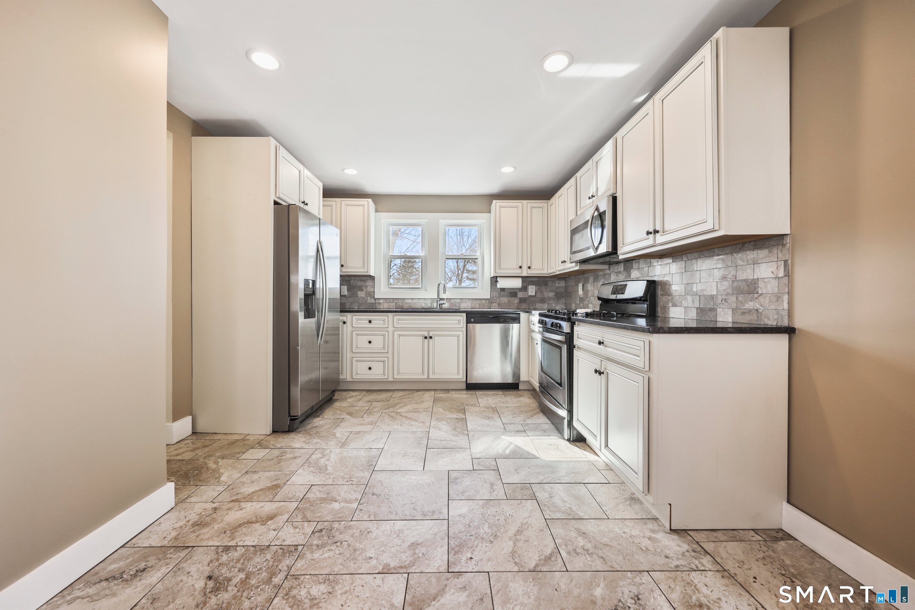 116 Hillside Avenue Torrington, CT 06790 - Photo 10 of 40 a kitchen with stainless steel appliances granite countertop a refrigerator and a stove top oven
