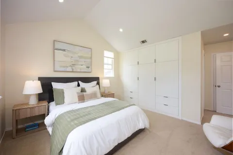 a bedroom with a bed and a chair