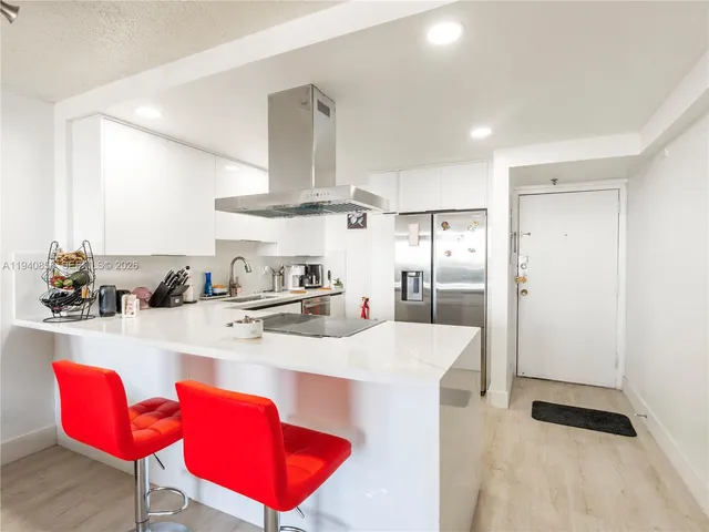 a kitchen with stainless steel appliances kitchen island granite countertop a sink and cabinets