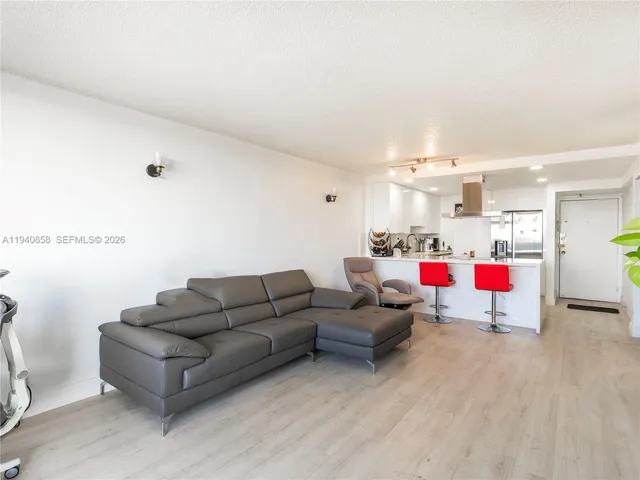 a living room with furniture and white walls