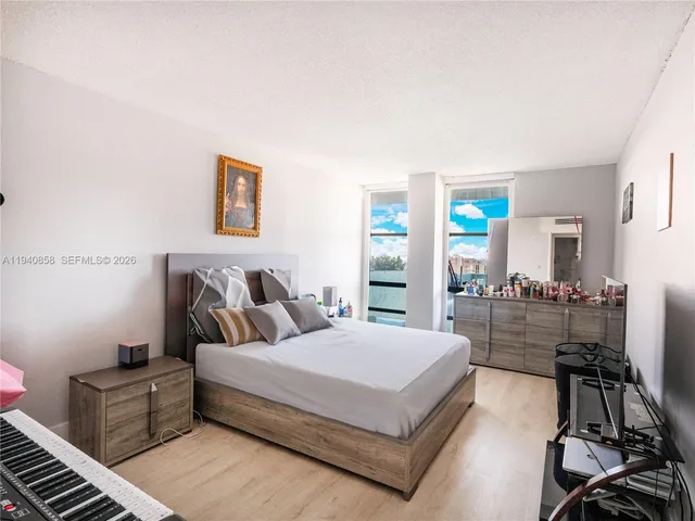 a large bedroom with a bed and furniture