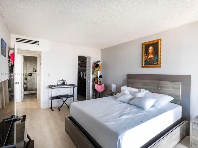 a bedroom with a bed and a table in it