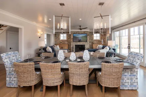 a dining room with furniture and a chandelier