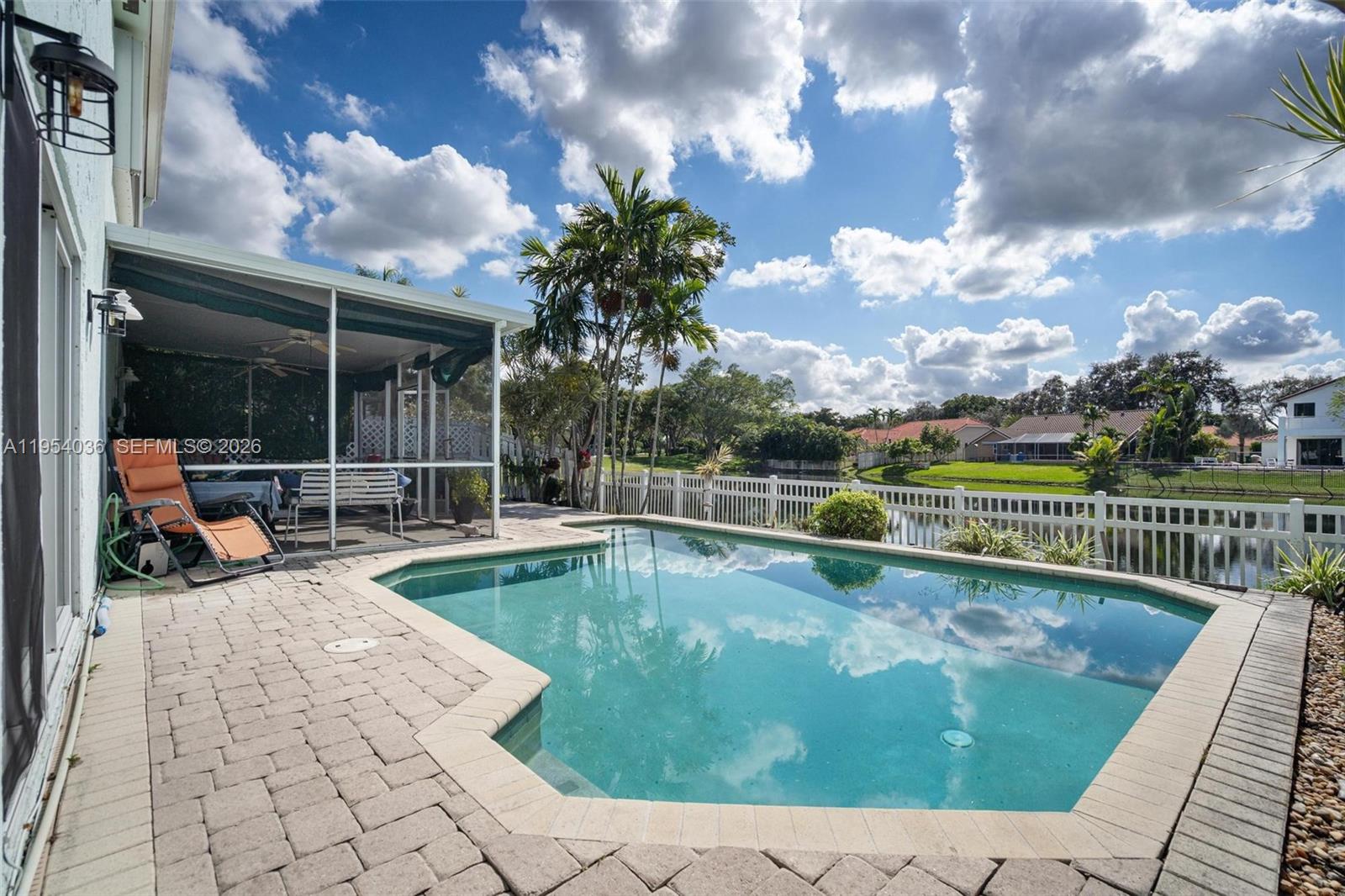 13930 Oak Ridge Drive Davie, FL 33325 - Photo 11 of 54 a view of a swimming pool with a lounge chair