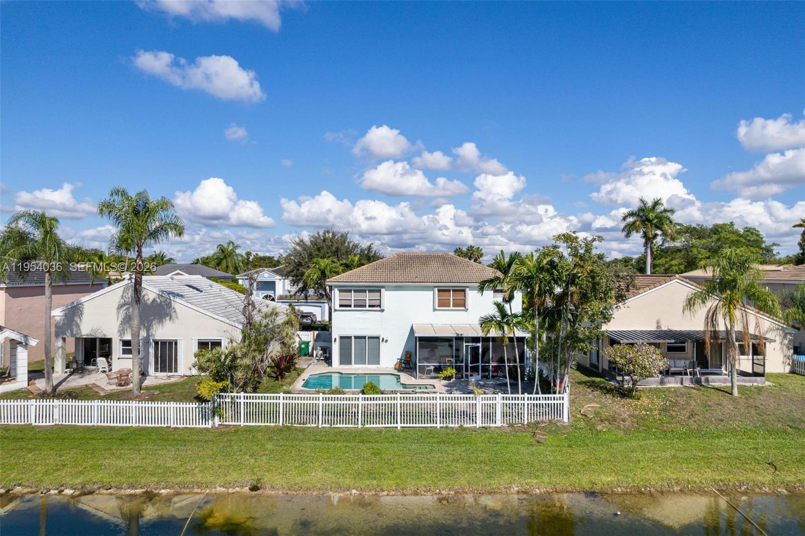 13930 Oak Ridge Drive Davie, FL 33325 - Photo 12 of 54 a front view of a house with a big yard