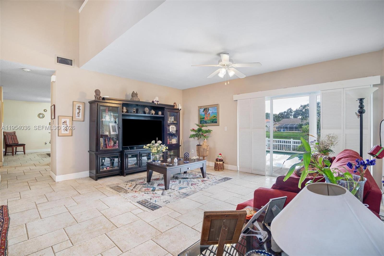13930 Oak Ridge Drive Davie, FL 33325 - Photo 20 of 54 a living room with furniture and a flat screen tv