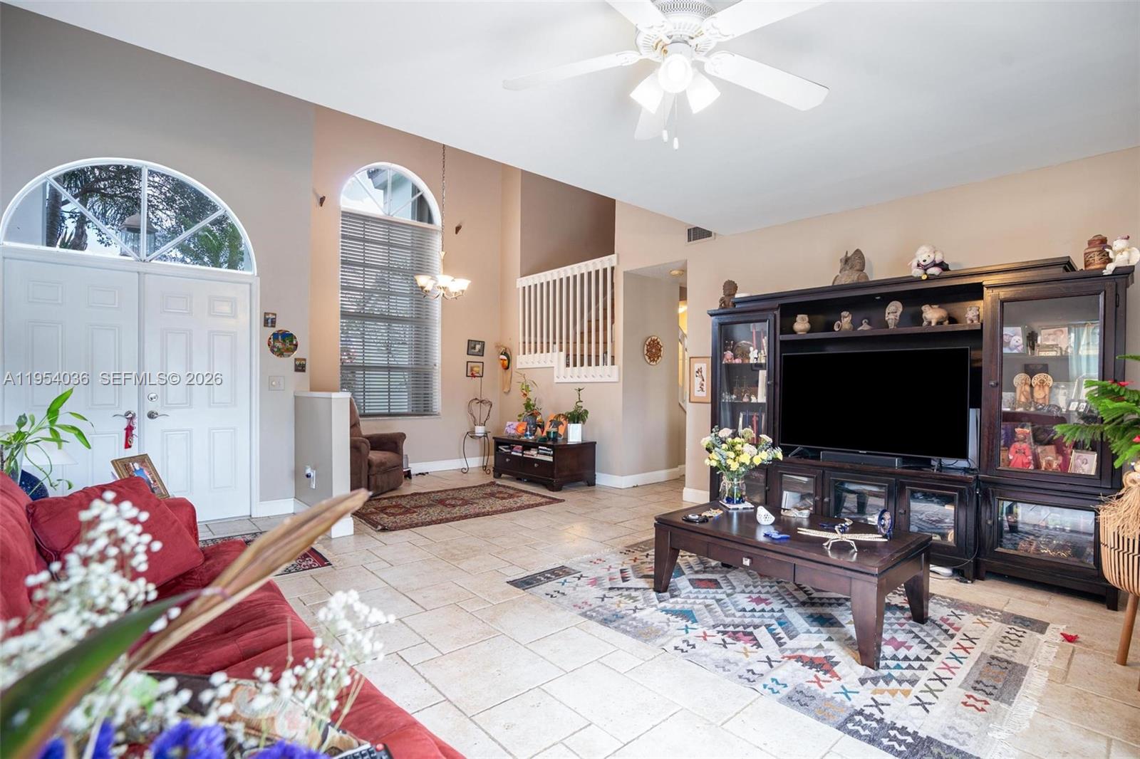 13930 Oak Ridge Drive Davie, FL 33325 - Photo 21 of 54 a living room with furniture and a flat screen tv