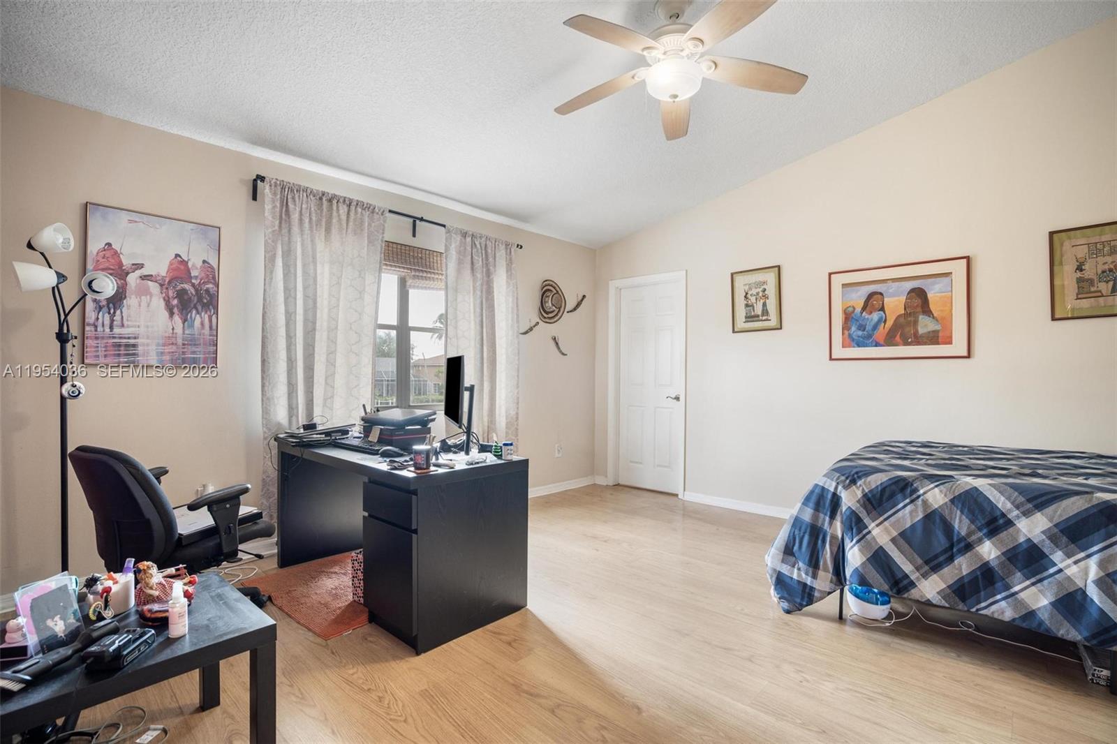 13930 Oak Ridge Drive Davie, FL 33325 - Photo 26 of 54 a bedroom with a bed and a chandelier