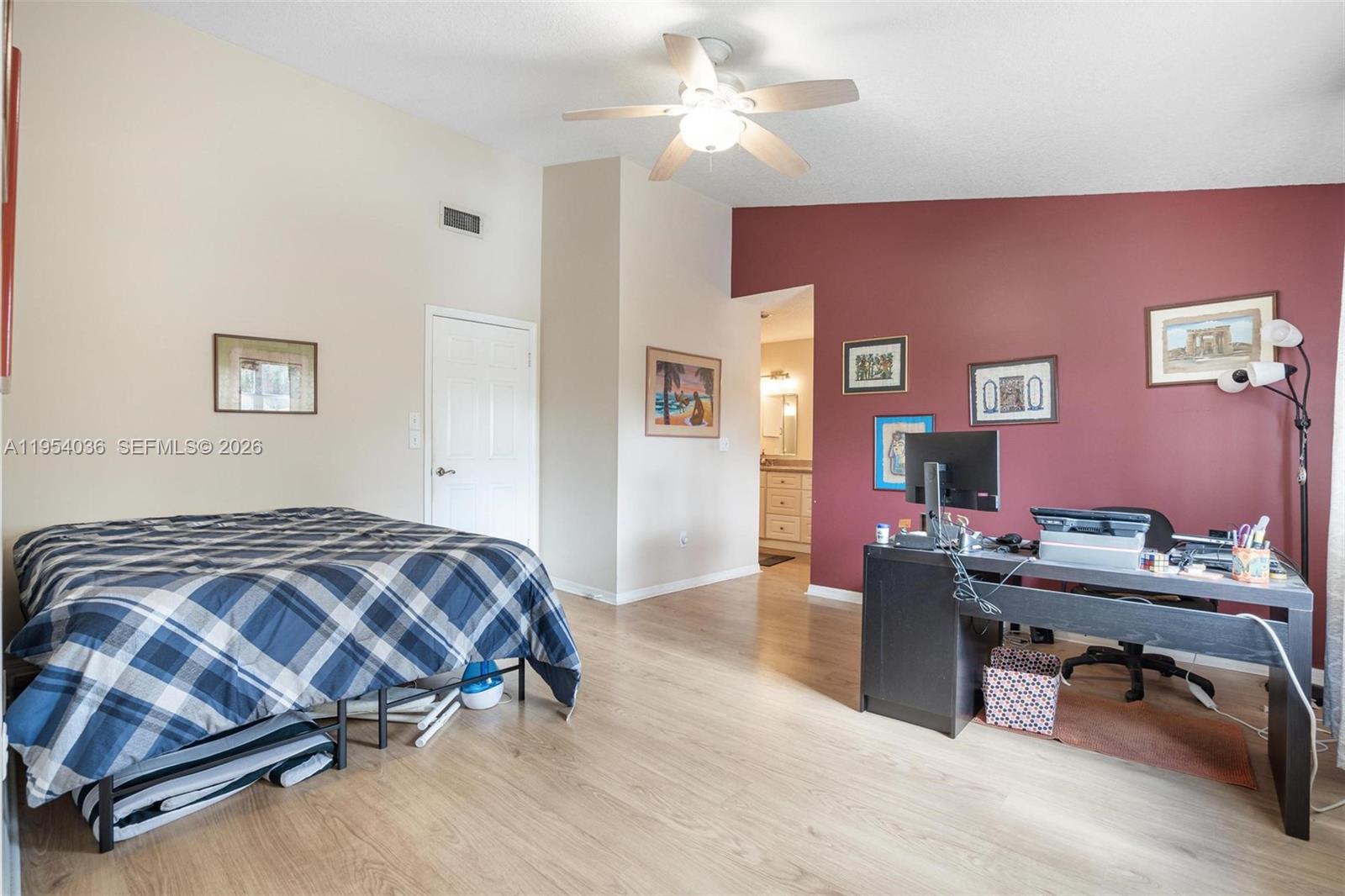 13930 Oak Ridge Drive Davie, FL 33325 - Photo 27 of 54 a bedroom with a bed and a chandelier