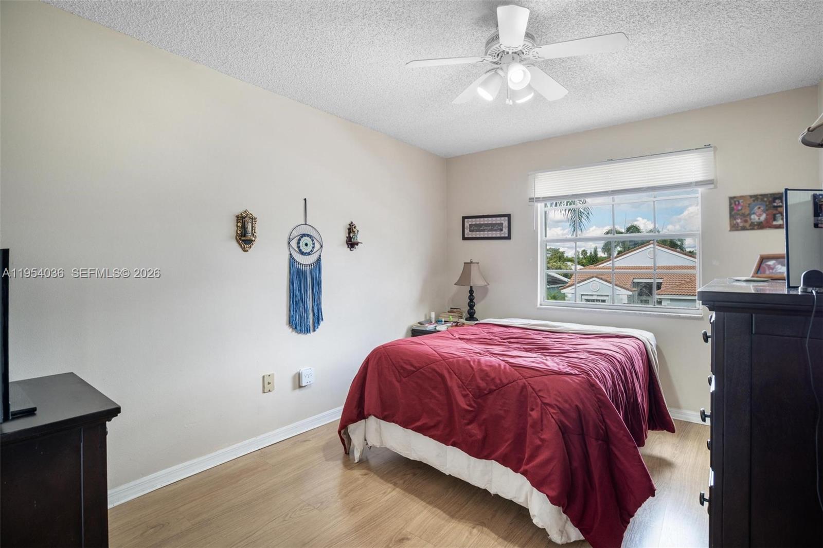 13930 Oak Ridge Drive Davie, FL 33325 - Photo 31 of 54 a bedroom with a bed and a chandelier