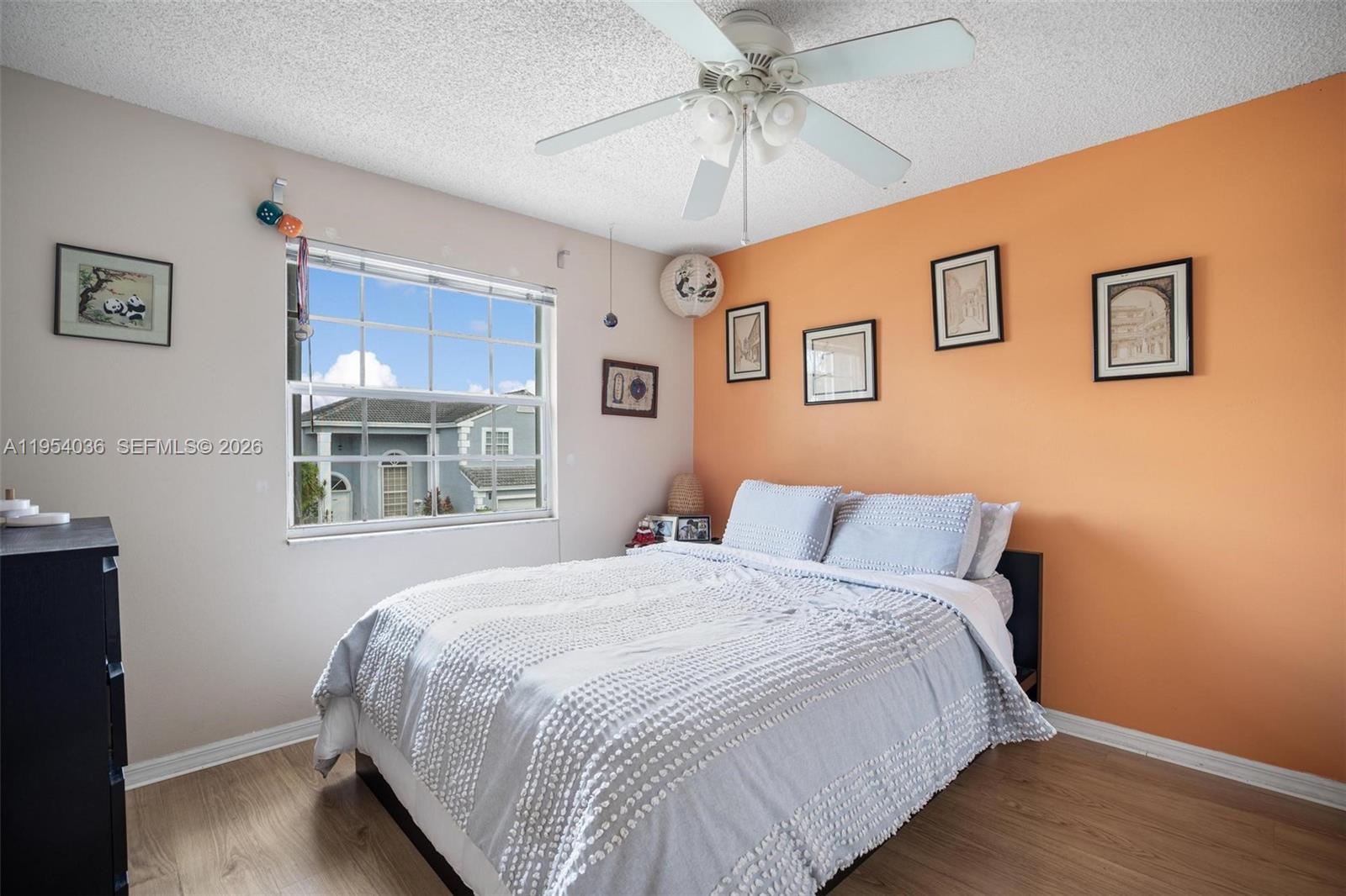 13930 Oak Ridge Drive Davie, FL 33325 - Photo 32 of 54 a bedroom with a large bed and a window