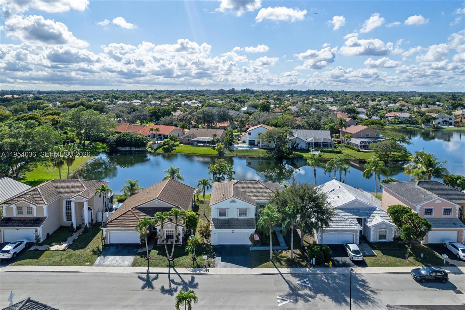 13930 Oak Ridge Drive Davie, FL 33325 - Photo 51 of 54 an aerial view of a house with garden space and lake view in back