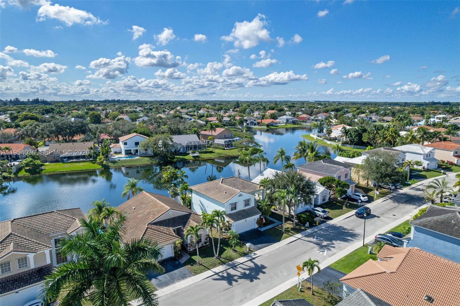 13930 Oak Ridge Drive Davie, FL 33325 - Photo 53 of 54 an aerial view of a houses with a lake view